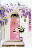 This serene doorway scene could easily belong to a hidden Maida Vale townhouse, captured at the exact moment when a new chapter begins. A pastel pink front door, smooth and freshly painted, stands beneath a soft wash of late-afternoon light, its colour radiating calm against the crisp, whitewashed walls. To one side, a coordinating blush shutter hints at a window just out of view, adding a sense of symmetry and gentle charm. Above and around the frame, wisteria cascades in lush abundance, its slender clusters of lavender and soft purple blooms spilling down in graceful arcs. The petals form a kind of floral veil, echoing the romantic greenery often seen climbing over façades near Little Venice and the quiet streets running off Randolph Avenue. At the doorstep, a tasteful grey bucket sits firmly on the stone step, overflowing with velvety white and cream roses. Each rose looks freshly opened, its layers of petals plush and full, cradled by soft green foliage that adds texture without disturbing the delicate colour palette. Around the bucket, a neat pink ribbon is tied in a loose bow, its refined simplicity binding the arrangement visually to the pink door and the wisteria above. Gentle sunlight filters through the blossoms and leaves, creating dapples of light and shade across the entryway, as if the flowers themselves are welcoming someone over the threshold. The image captures that mix of excitement and quiet reassurance that comes with settling into a new flat or house in Maida Vale, making it an ideal floral expression of congratulations, hope, and the tender feeling of finally arriving home.