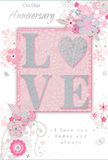 This anniversary card presents a tender, romantic scene in soft pastel pinks, silvery greys, and pearly whites, echoing the understated elegance of Maida Vale terraces. At the centre of the design, the word LOVE stands in gently raised glitter, each letter delicately outlined, with the O replaced by a shimmering silver heart that appears carefully inset, like a treasured charm. The textured finish invites touch, adding a tactile richness similar to running your fingers along the velvety petals of a fresh rose from a local florist near Clifton Road. Surrounding this focal word, an arrangement of delicate, stylised blossoms unfurls in blush, mauve, and soft ivory tones. Their petals have a watercolour softness, with fine, flowing outlines that suggest both movement and care, like the loose strokes of an artist sketching an English spring garden. Between the blooms, graceful swirls, tiny petals, and subtle butterfly motifs drift and dance, giving the impression of a light breeze passing over a flower bed by the canal. The top of the card carries the phrase On Our Anniversary in a refined script, while the words I love you today and always rest below in the same gentle lettering, joining the artwork without overpowering it. The entire composition feels serene, intimate, and thoughtfully arranged, much like an anniversary bouquet delivered to a Maida Vale doorstep. It captures the sense of a shared journey-quiet, enduring, and full of affection-making the card an ideal keepsake to accompany a romantic evening at home.